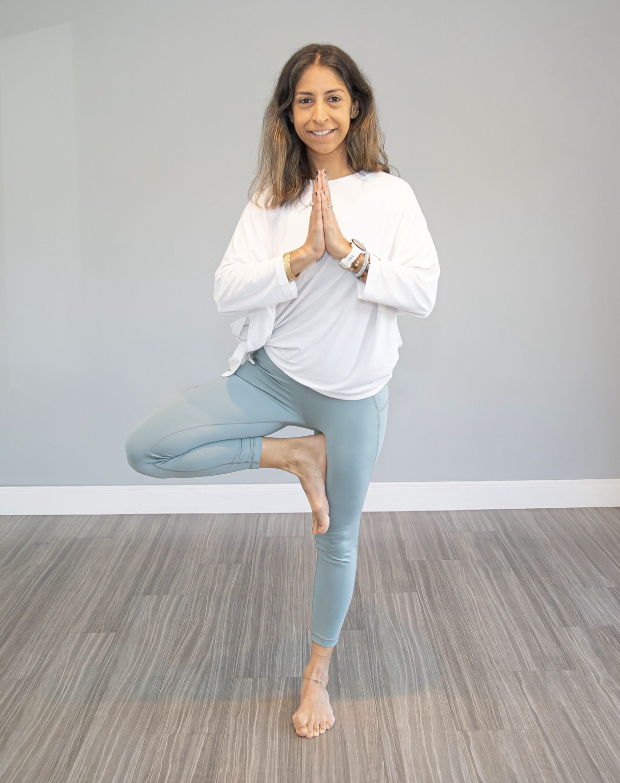 Woman standing in tree pose